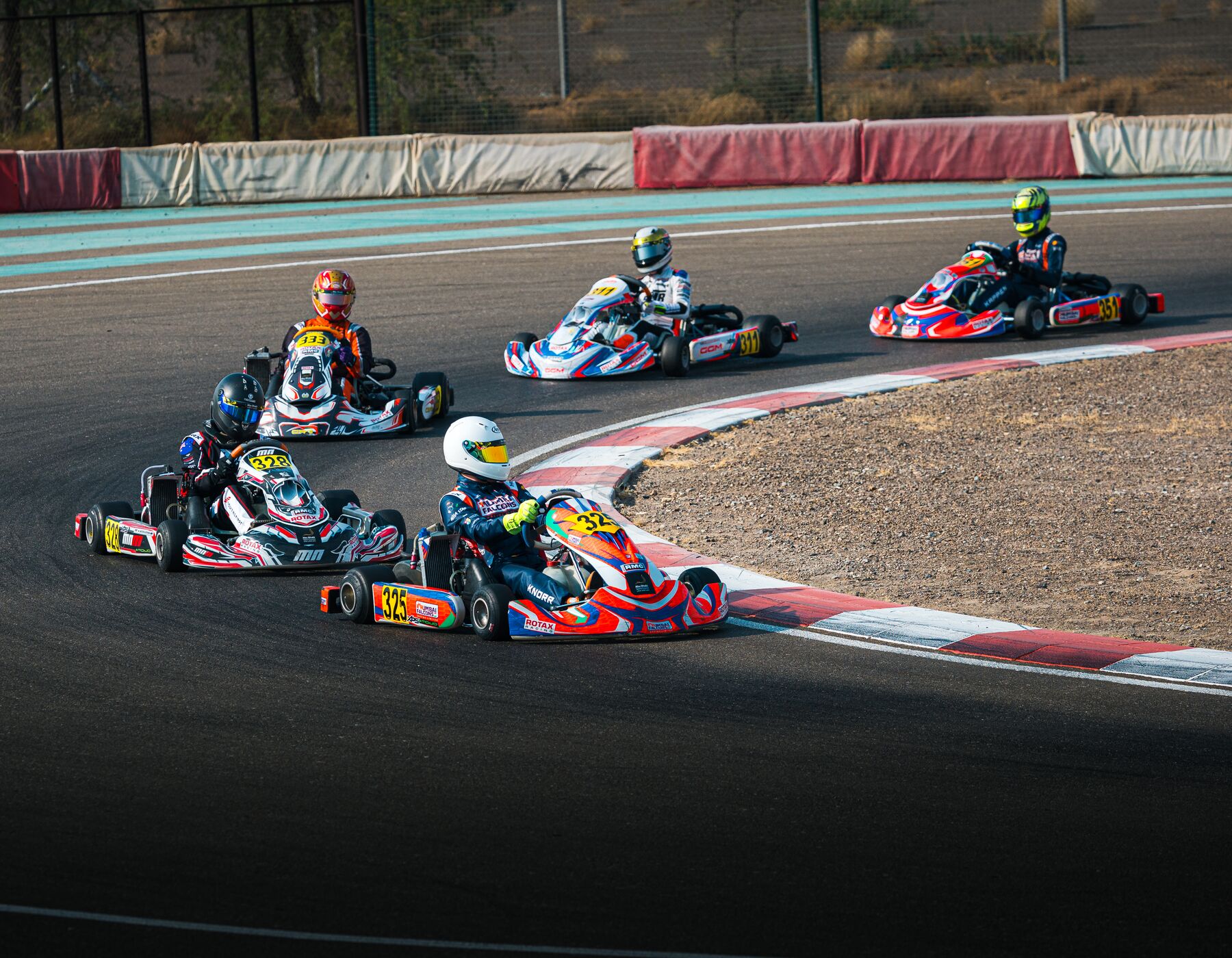 Damian Knorr #325 in a tight group through a corner, Al Ain Raceway