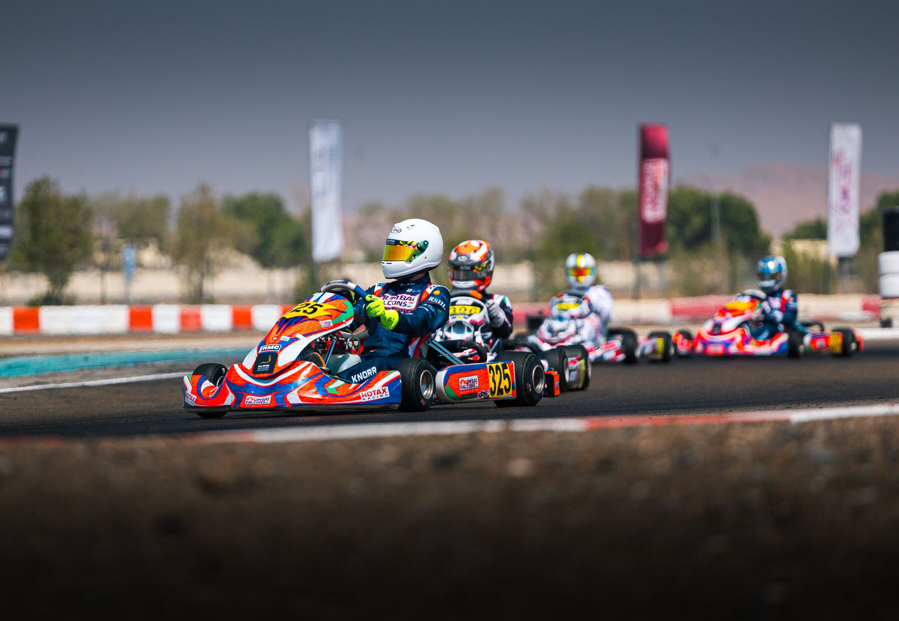 Damian Knorr #325 racing in traffic, Rotax Invitational