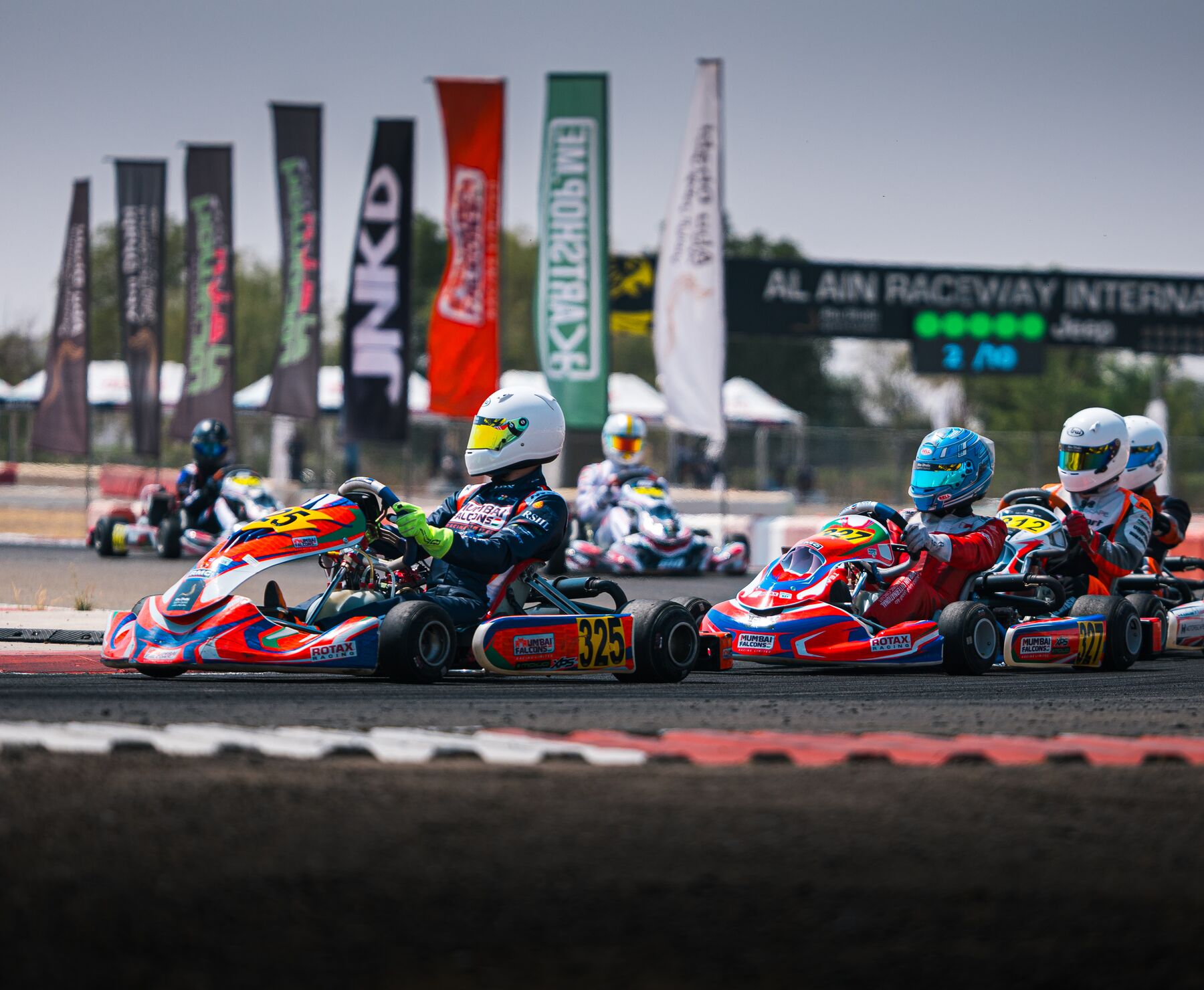 Damian Knorr #325 side by side with a rival, Al Ain Raceway