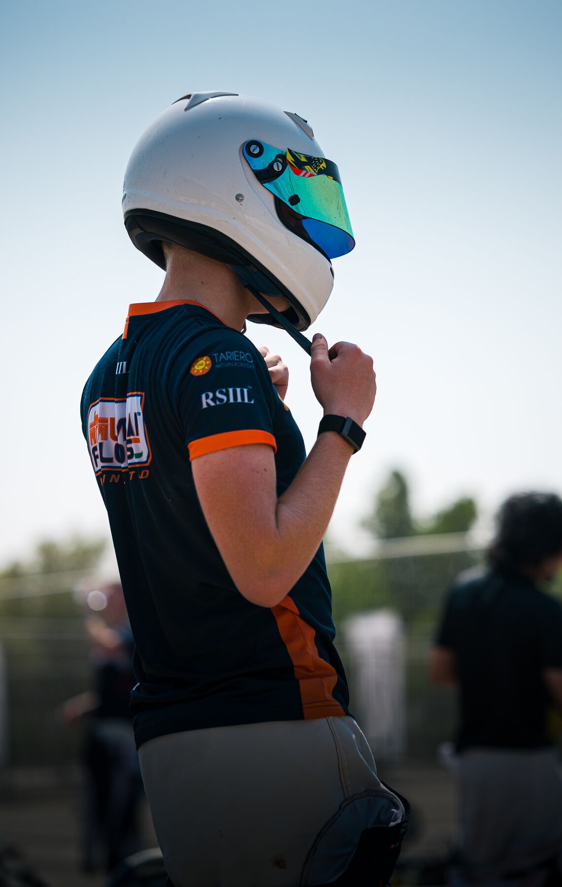 Damian Knorr fastening his helmet before the session